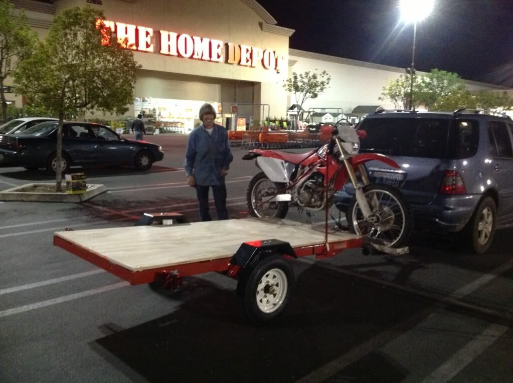 A Harbor Freight 4'x8' folding trailer will hold 3 full size dirt bikes